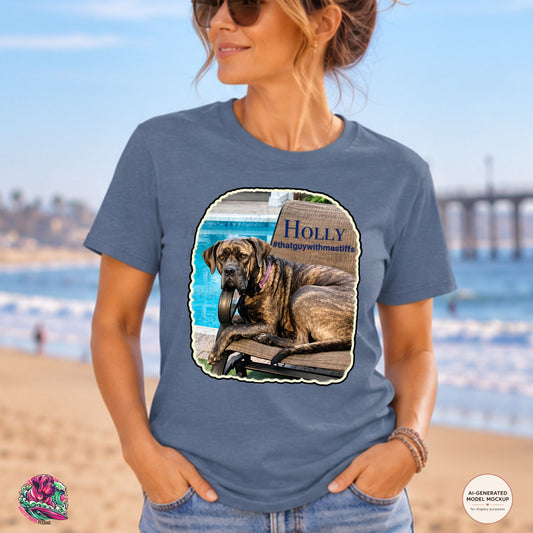A woman wearing Heather Indigo Gildan Unisex Softstyle t-shirt mockup featuring Holly’s Poolside Queen Tee artwork featuring a brindle mastiff lounging by the pool for That Guy With Mastiffs merch by Mastiff Mama Designs. 